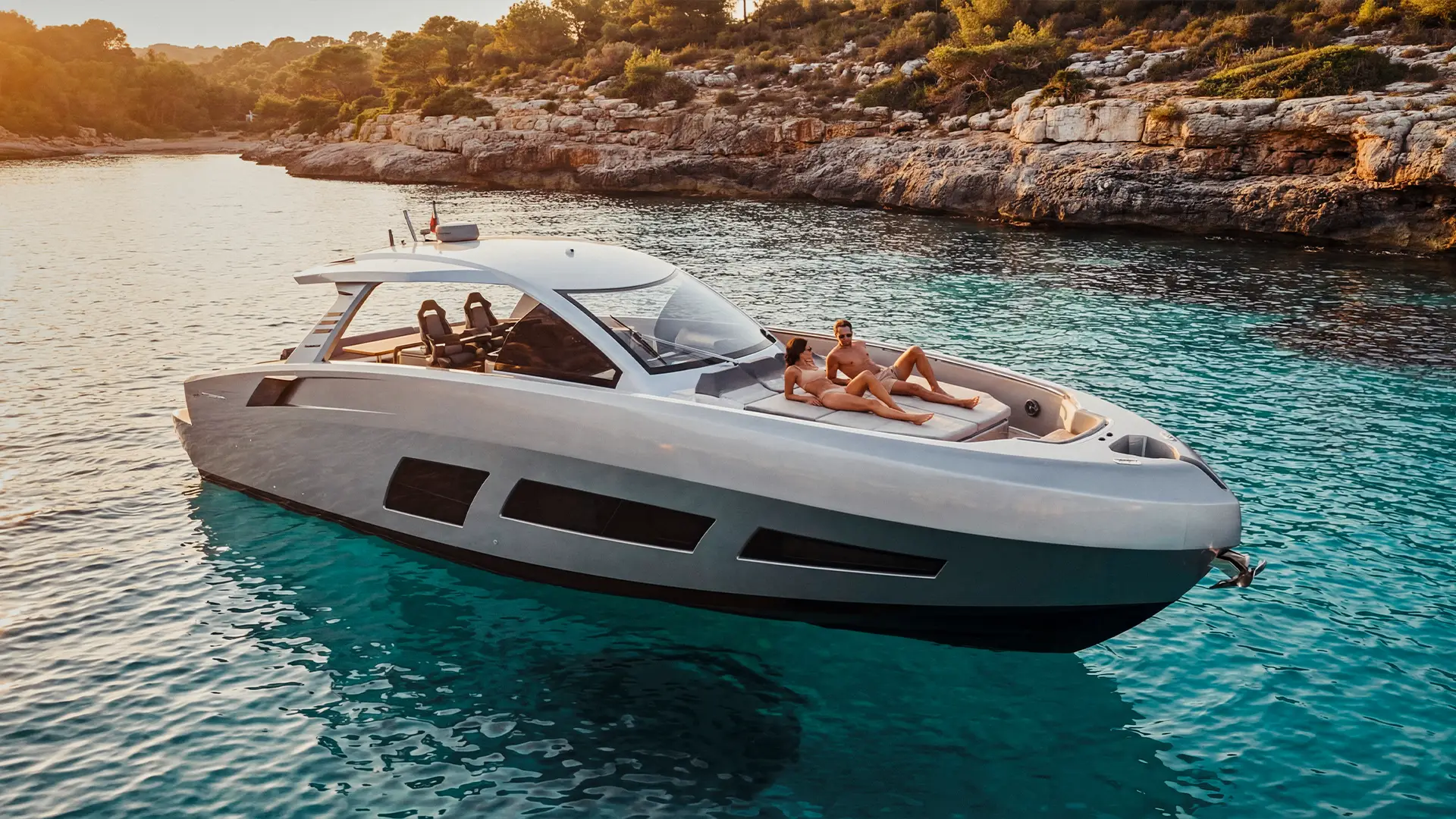 Drone aerial view of the Canados Gladiator 631 OK Next anchored in a turquoise bay along the Mallorca coastline